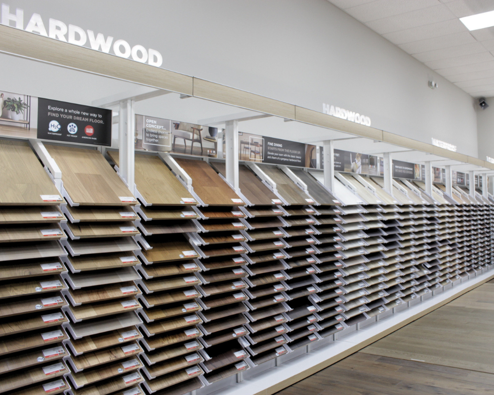 Great Southeast Showroom display of hardwood flooring samples, with rows of different wood finishes arranged on shelves and angled stands under a 